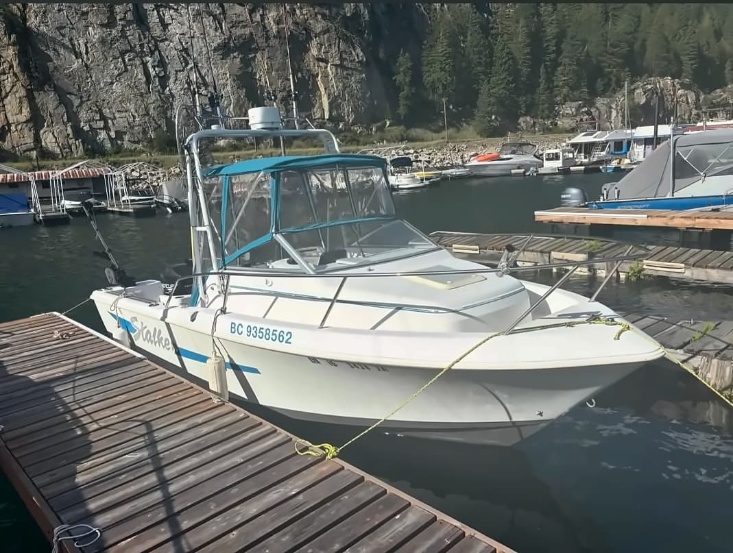 The Stalker, a white rental boat with a hard top, tied up at the Scotties Marina dock.